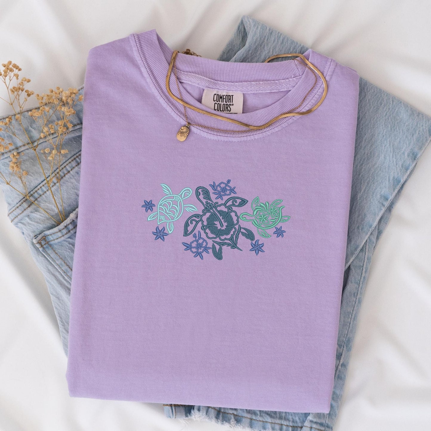 a t - shirt with a turtle on it sitting on a bed