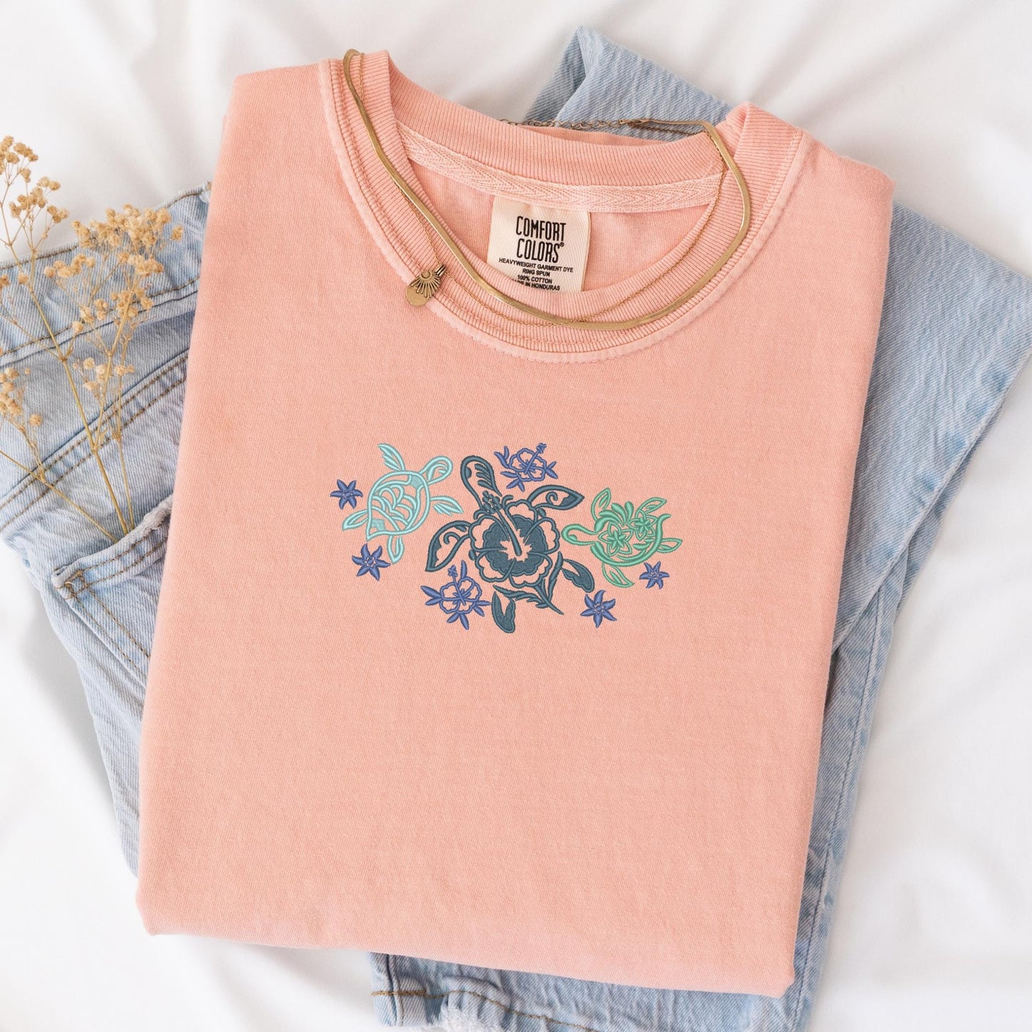 a pair of jeans and a t - shirt on a bed