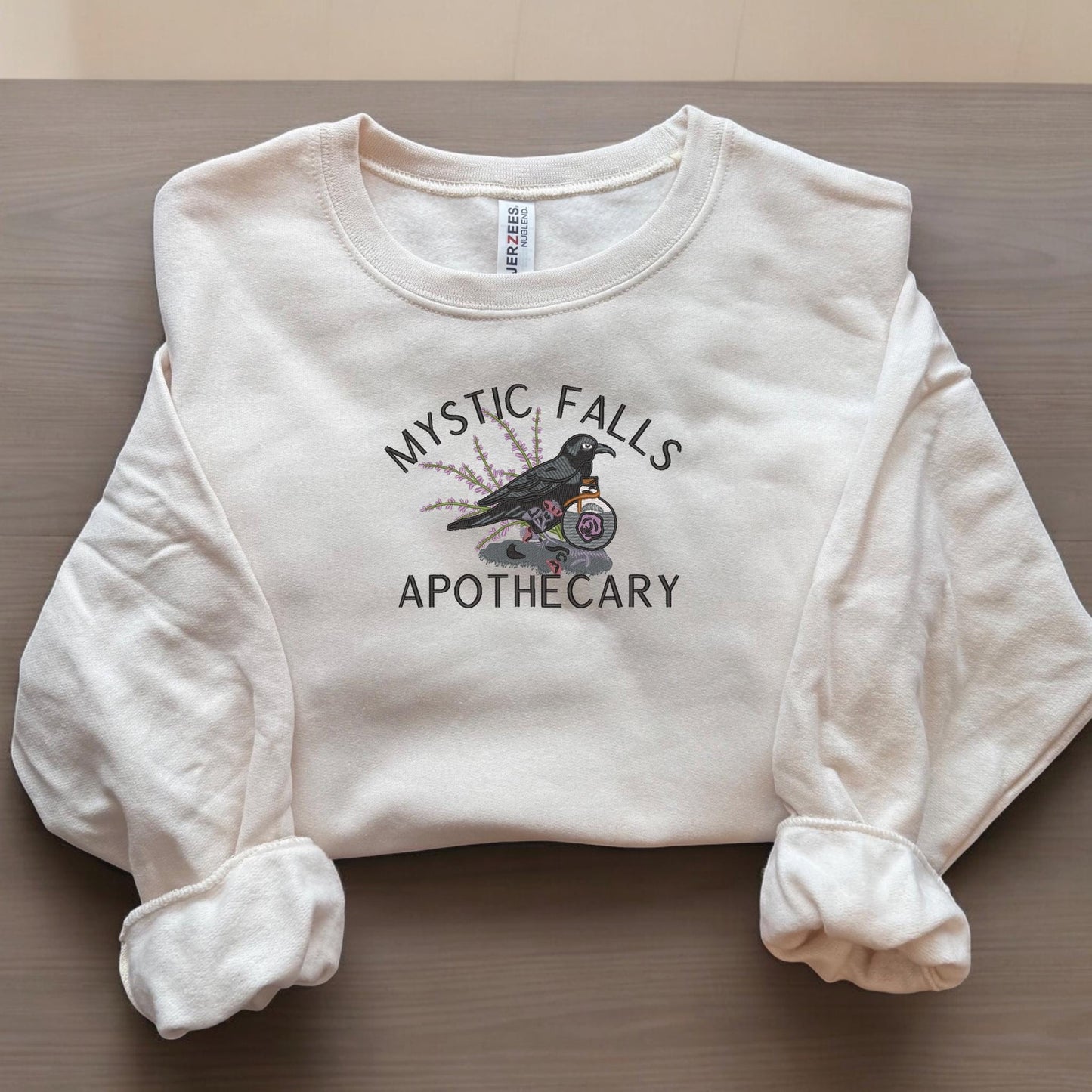 a white sweatshirt with a bird on it