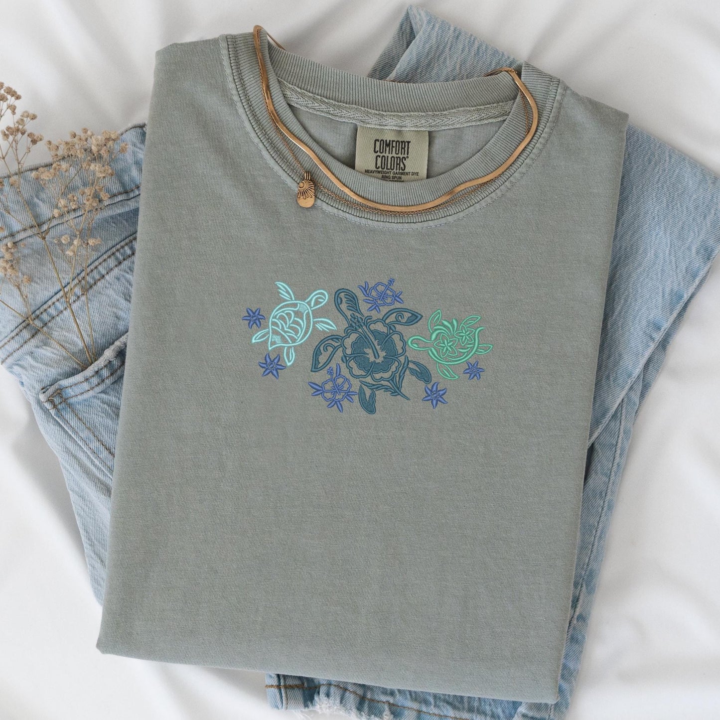 a pair of jeans and a turtle t - shirt on a bed