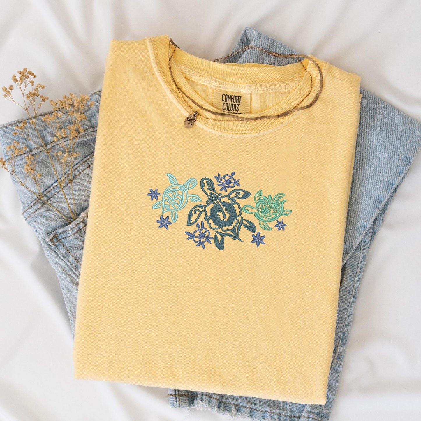 a pair of jeans and a t - shirt on a bed