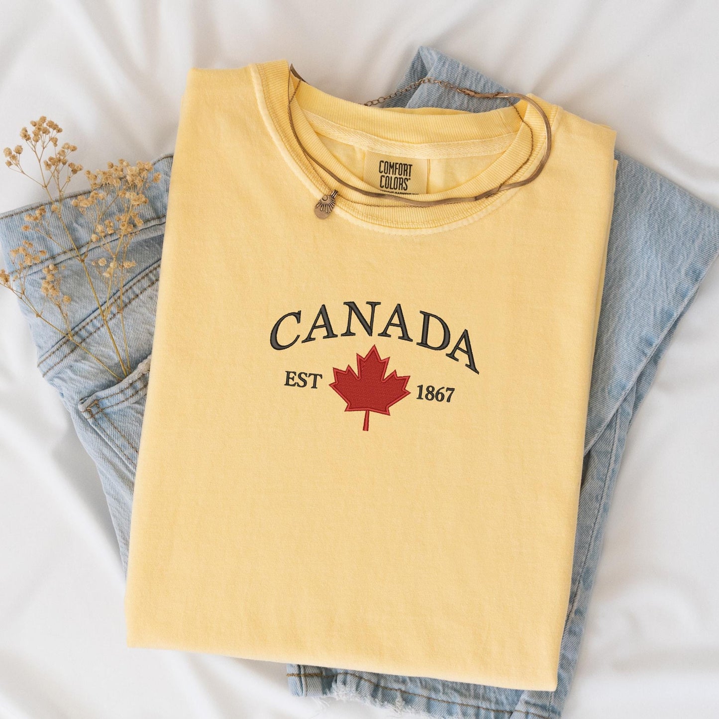 a yellow shirt with a canadian maple leaf on it
