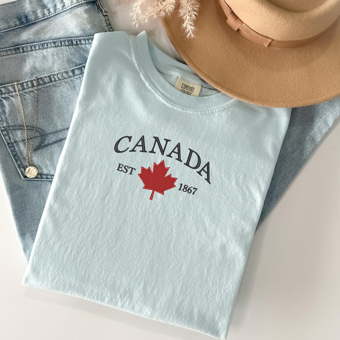 a pair of jeans and a hat on a table
