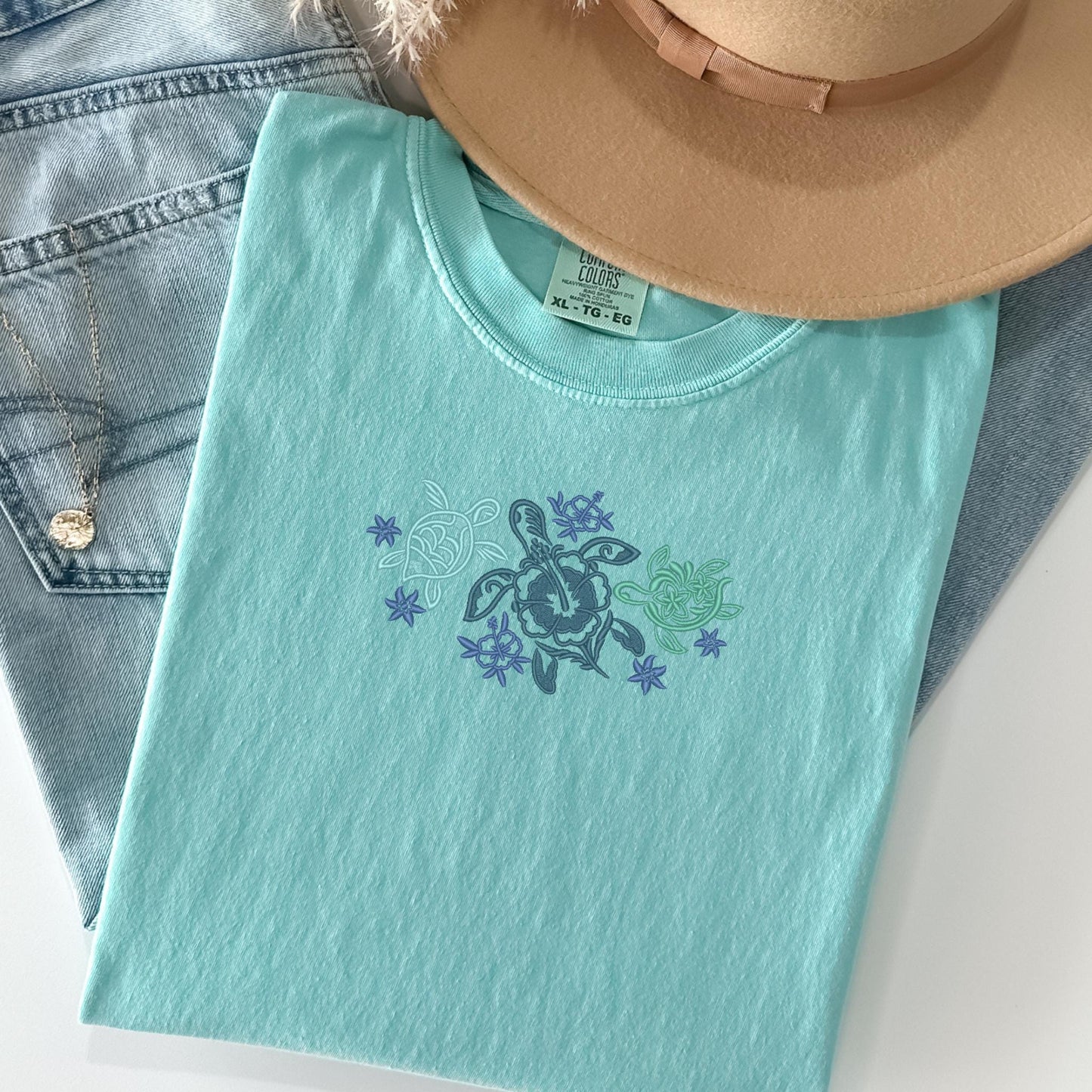 a hat, jeans, and a t - shirt on a table